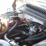 Under the hood of CNG Chevy Suburban, showing regulator, and fill valve.
